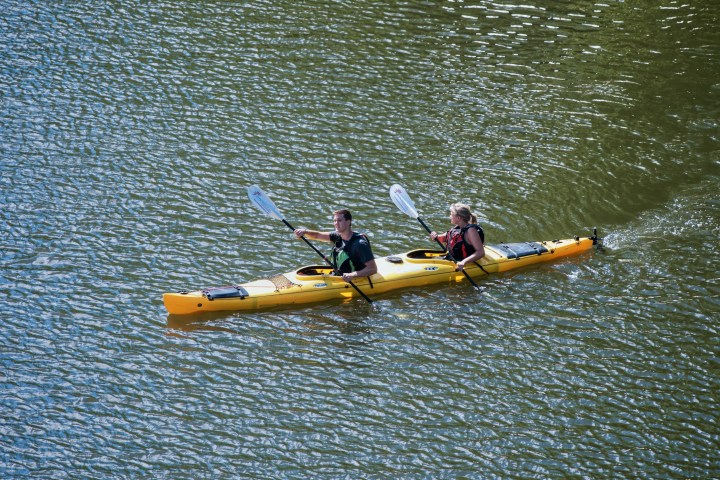 a small yellow boat on a body of water
