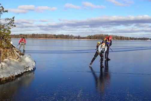 two people ice skating in a lake outside of Stockholm