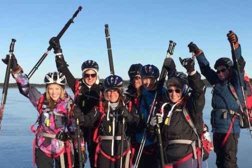 a group of happy ice skaters posing for the camera