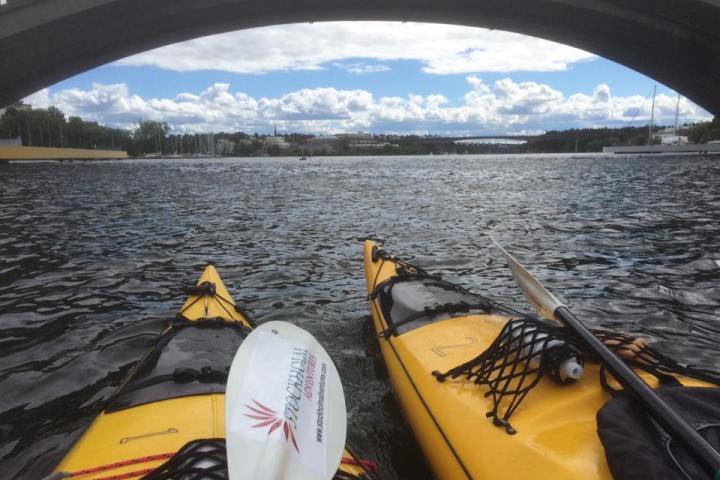 a yellow boat sitting on top of a bridge over a body of water