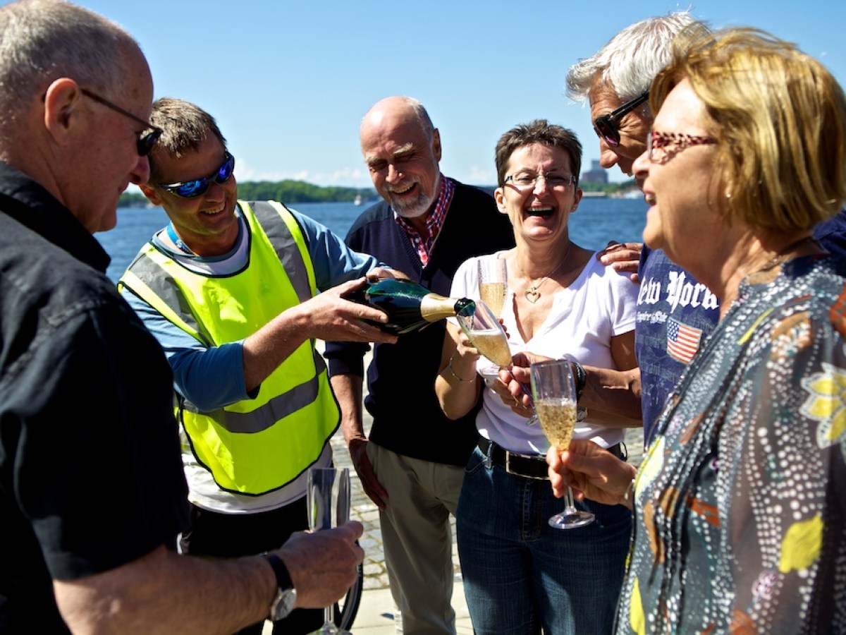 a group of people holding wine glasses
