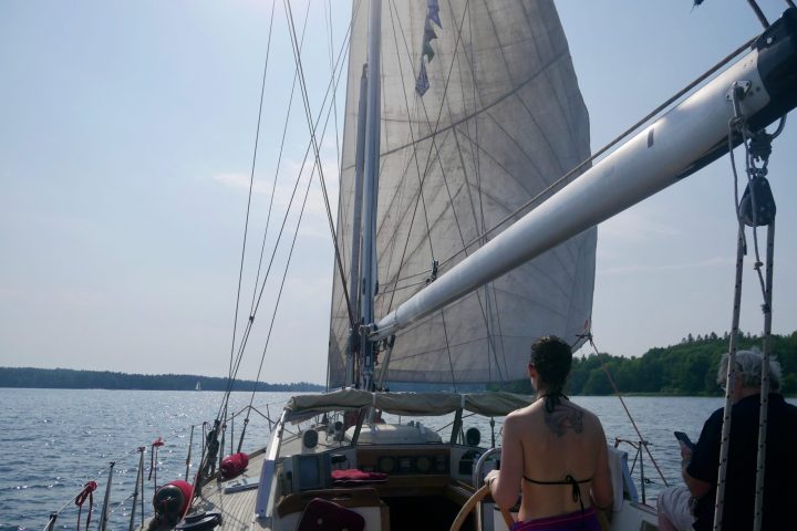 a group of people standing in front of a large ship in the water
