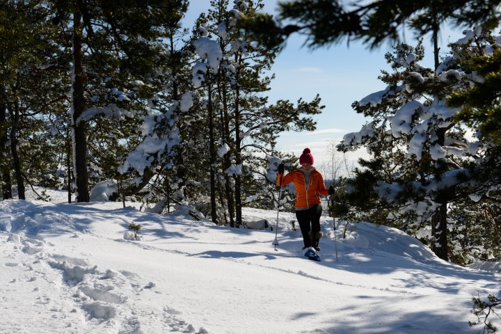 a man riding skis down a snow covered slope