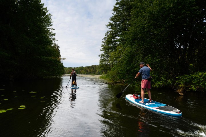 a man riding on the back of a boat in the water