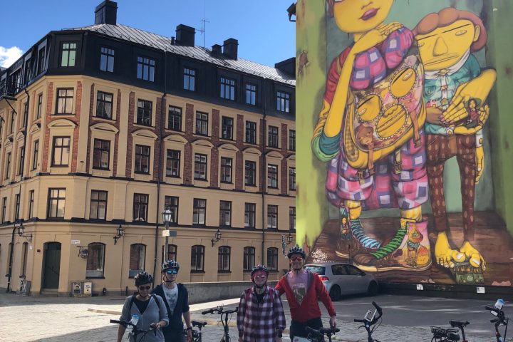 a group of people riding on the back of a bicycle