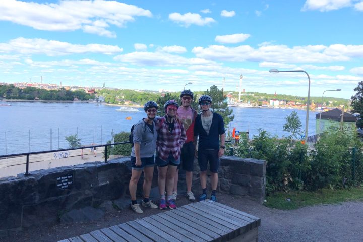 a man and a woman standing in front of a bridge