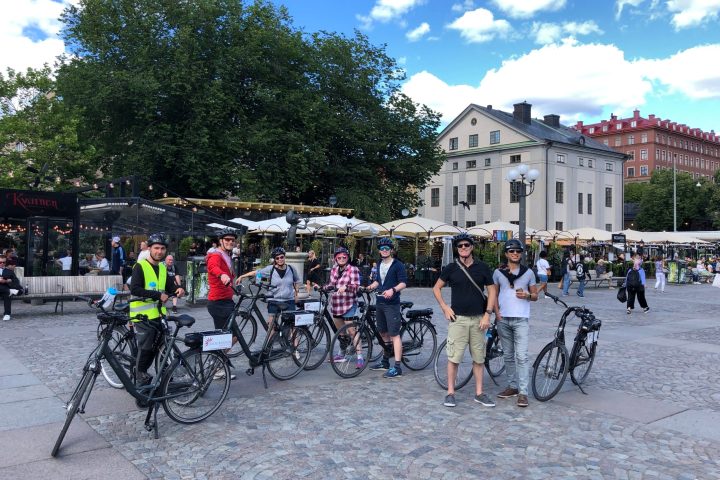 a group of people riding on the back of a bicycle