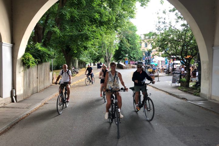 a group of people riding on the back of a bicycle