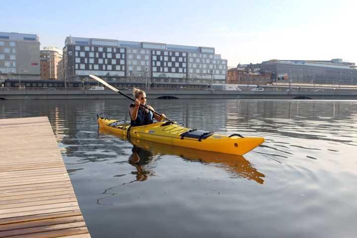 a yellow boat sitting on top of a body of water