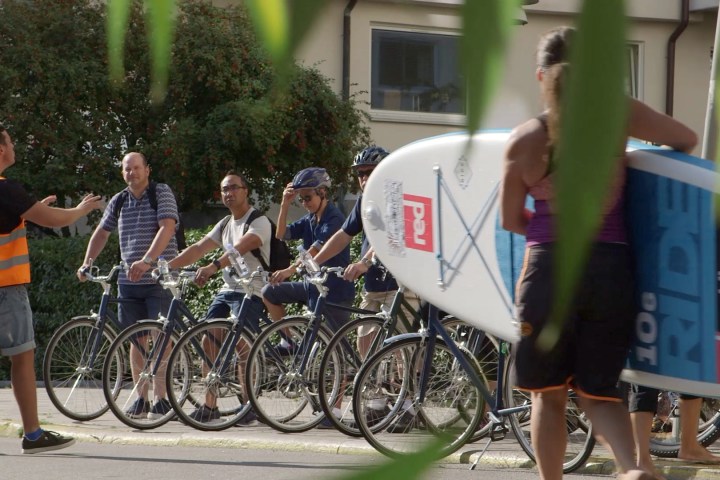 a group of people riding on the back of a bicycle