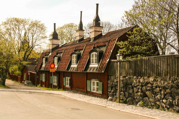 a church with a clock on the side of a road