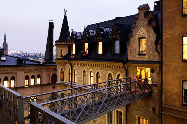 a large building with a clock on a bridge