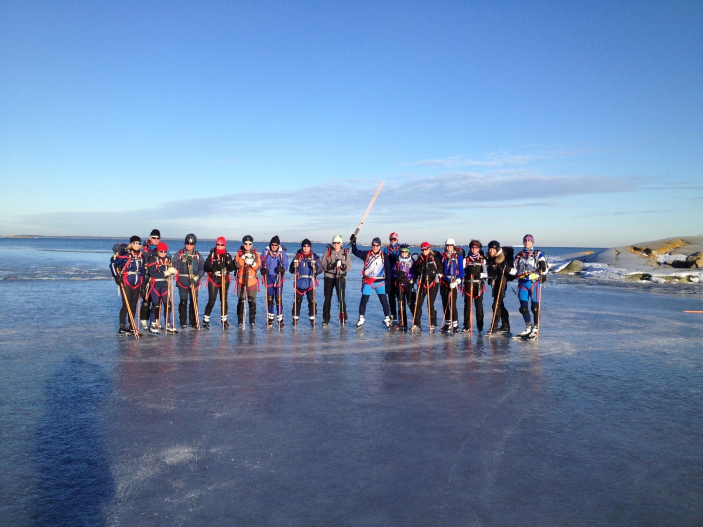 a group of people on a beach near a body of water