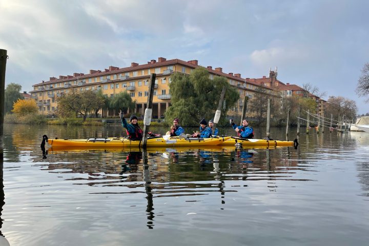 a group of people in a small boat in a body of water