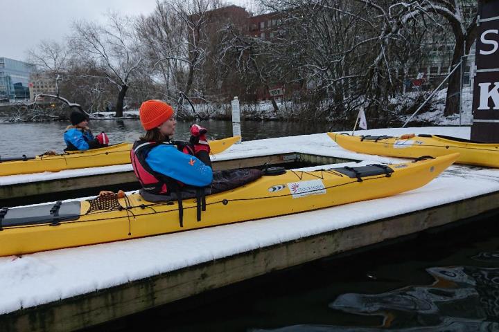 a person siting on a kayak during winter