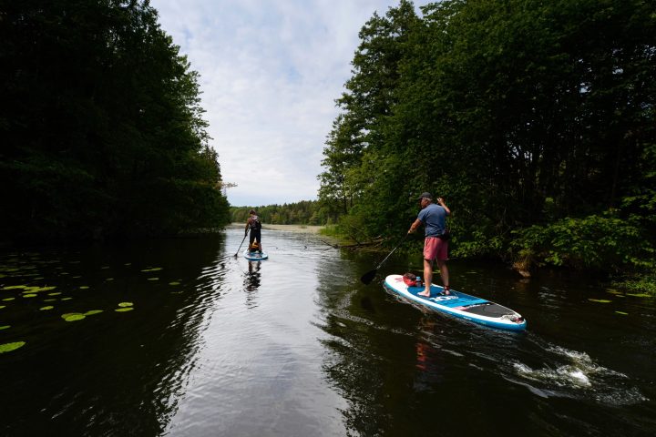 a man riding on the back of a boat in the water